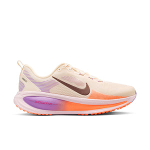 Beige running shoe with purple and orange accents on a white background