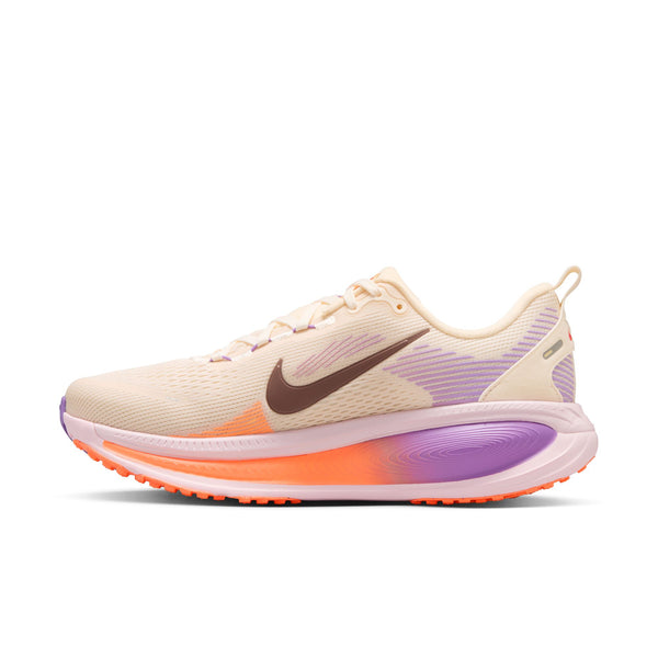 Beige running shoe with purple and orange accents on a white background