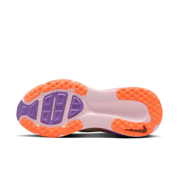 Close-up of a shoe sole with orange and purple tread pattern on a white background