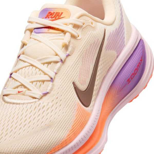 Beige running shoe with purple and orange accents on a white background