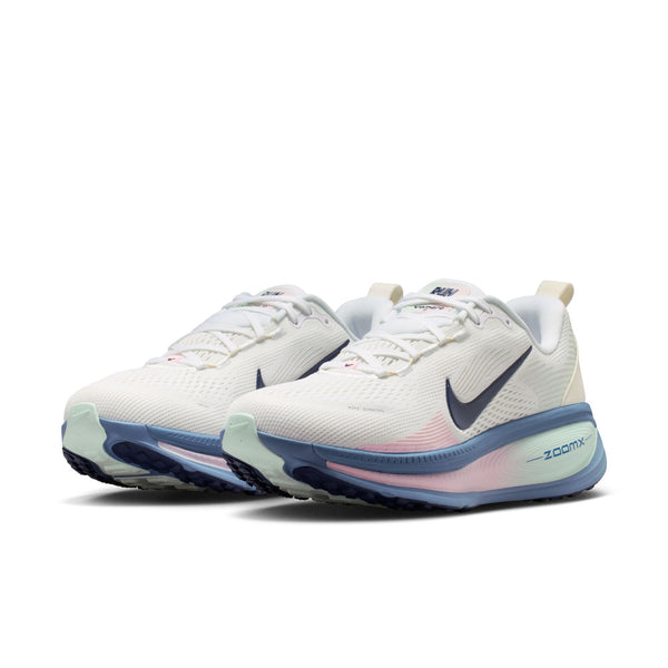 Pair of white running shoes with blue and pink accents on a white background