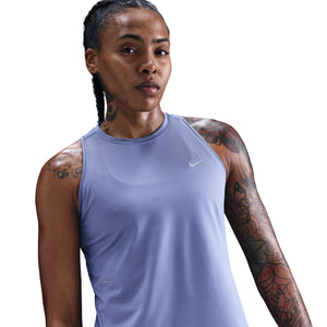 Woman wearing a light purple Nike tank top on a white background