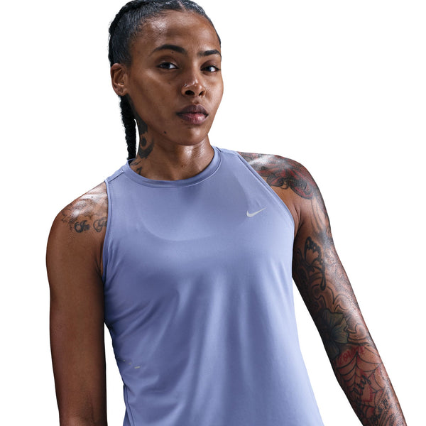 Woman wearing a light purple Nike tank top on a white background
