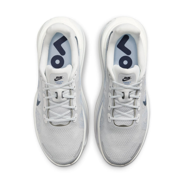 White athletic shoes with blue swoosh logo on a white background