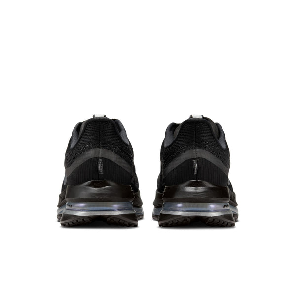 A pair of black athletic Nike shoes with a focus on the heel area on a white sole on a white background.