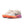 Beige running shoes with orange and purple sole on a white background