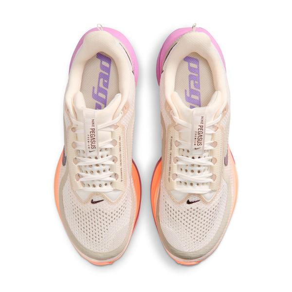 Pair of running shoes with a white and orange sole on a white background