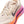 Beige running shoe with pink and orange sole on a white background