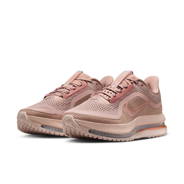Pair of pink Nike running shoes on a white background.