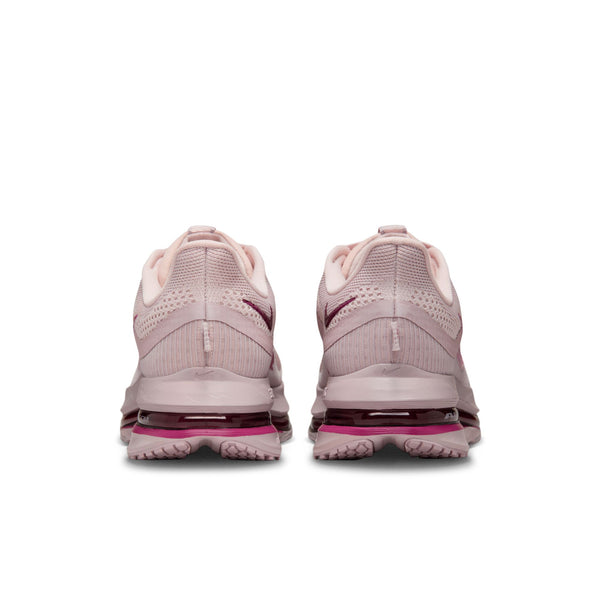 The heel area of a women's pink athletic shoes with a visible sole design on a white background.