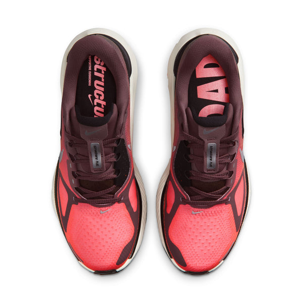 Red and black athletic shoes with visible brand logo on a white background