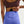 Person wearing a maroon sports bra and blue leggings on a light gray background