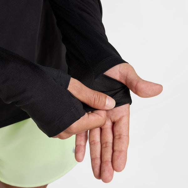 Person wearing a black wrist wrap on a plain background