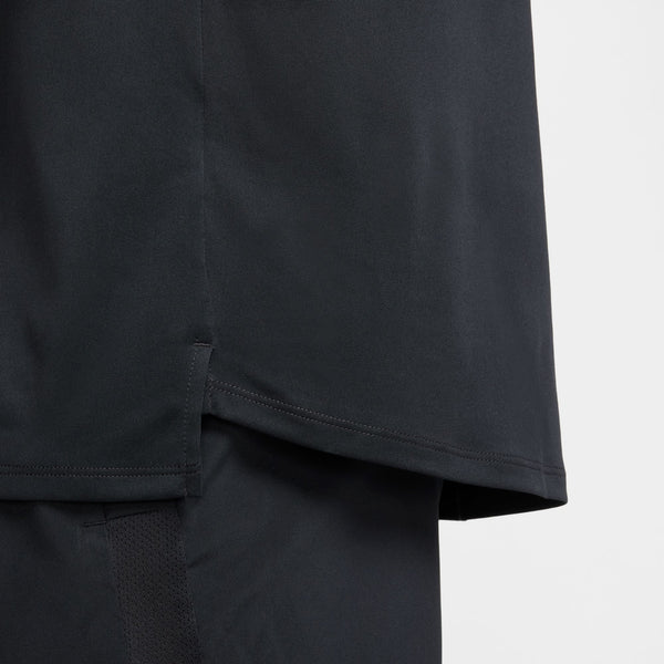 Close-up of a black t-shirt with a plain background