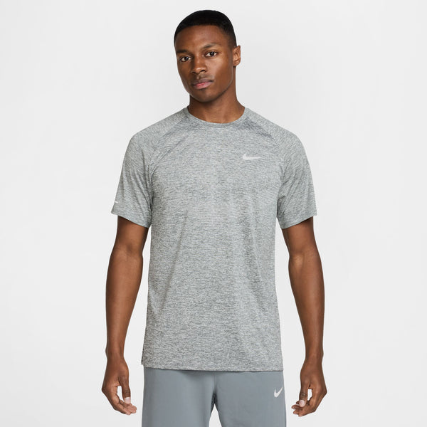 Man wearing a gray Nike t-shirt and pants on a white background