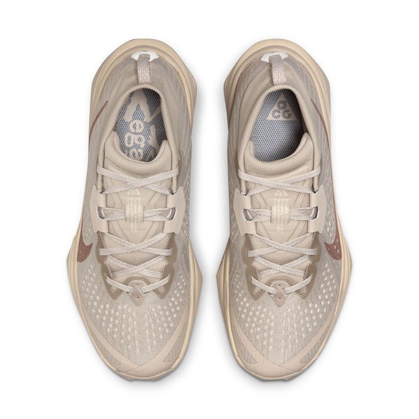 Pair of beige athletic shoes on a white background