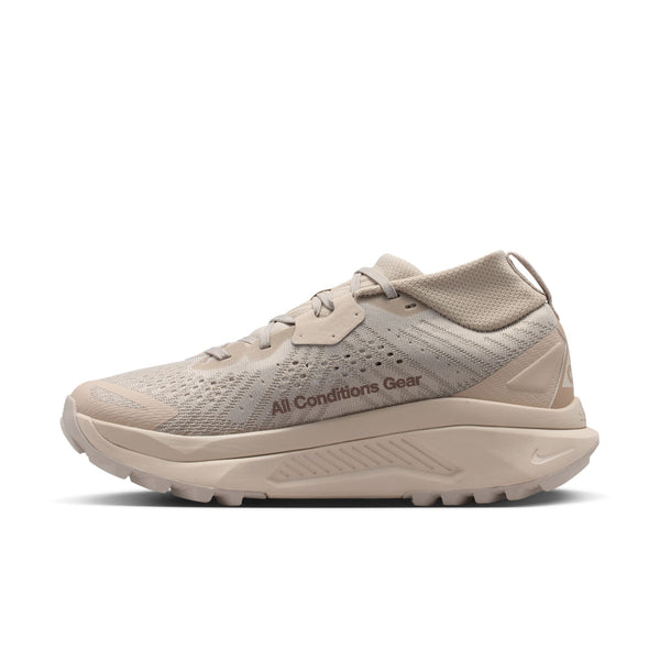 Beige running shoe with 'All Conditions Gear' text on a white background