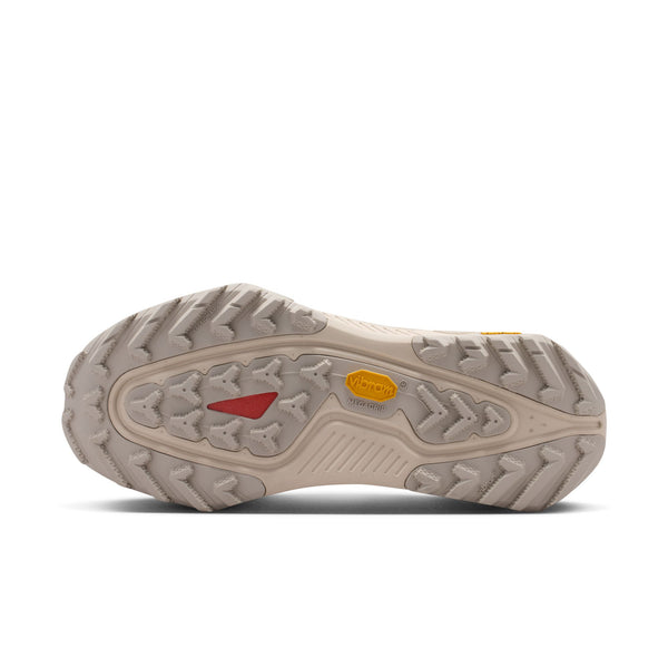 Close-up of a beige shoe sole with tread pattern on a white background