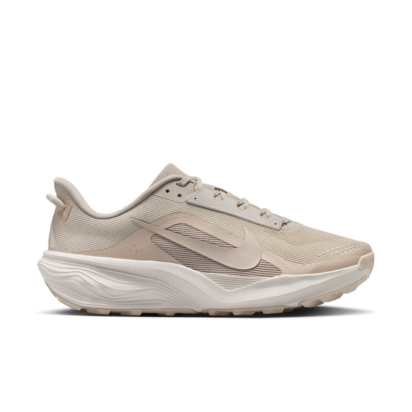 Beige Nike trail running shoe with a white sole on a white background
