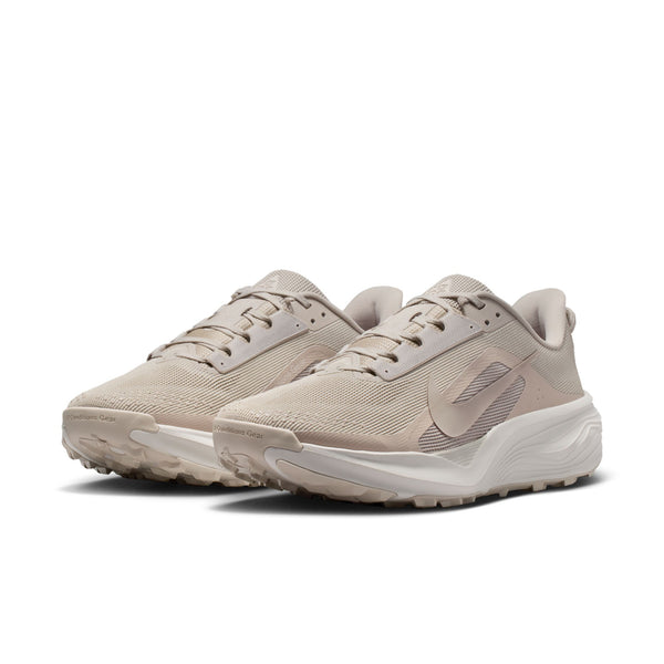Pair of beige running shoes on a white background