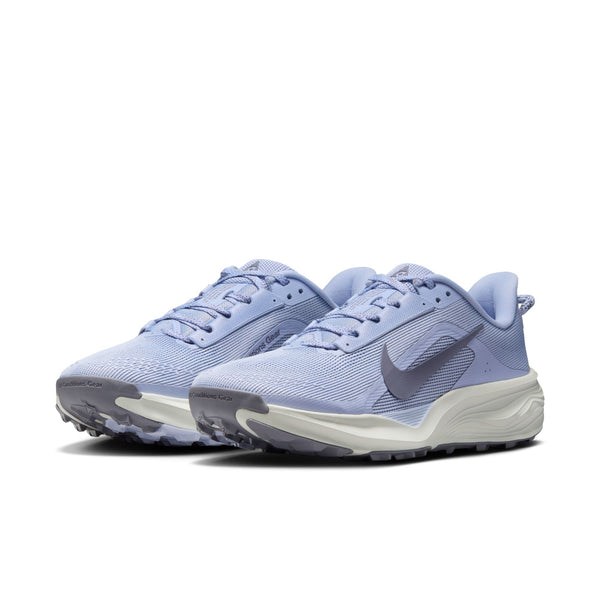 Pair of light blue running shoes with a Nike logo on a white background