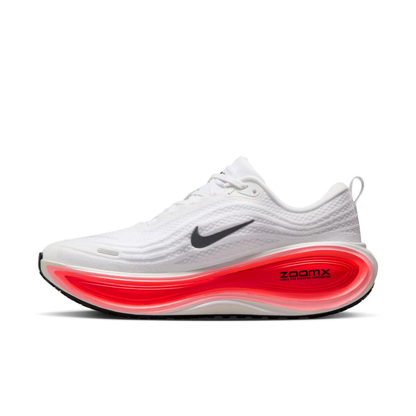 The medial side of this white running shoe with red sole on a white background.