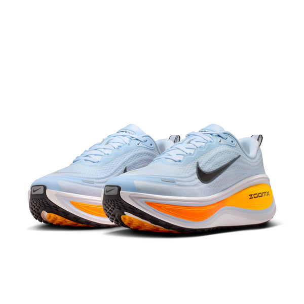 A pair of men's Nike hoes with a light blue upper and a neon midsole.