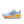 Light blue running shoe with orange sole on a white background