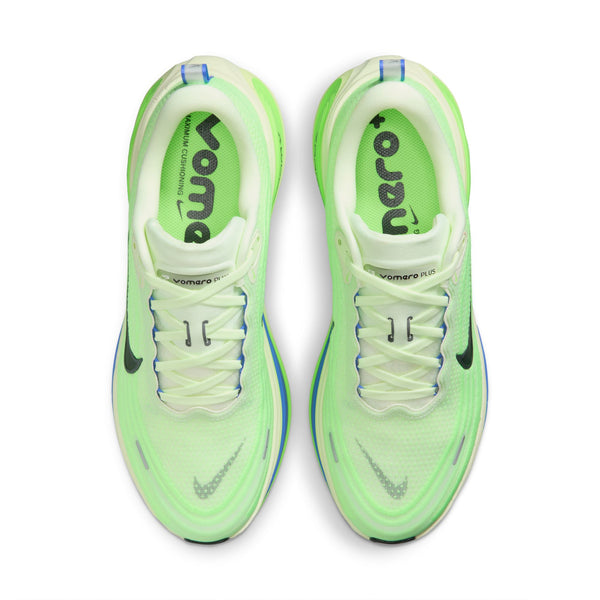 Pair of neon green running shoes with white soles on a white background