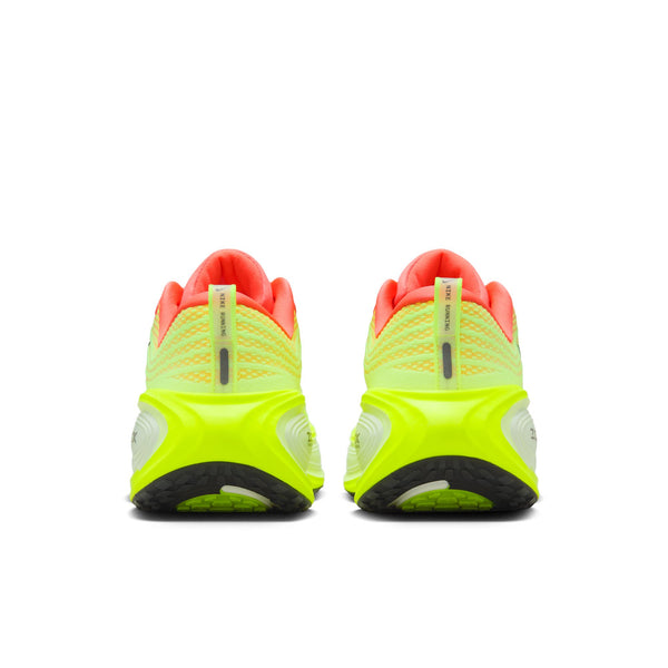Pair of neon green running shoes with pink accents on a white background.