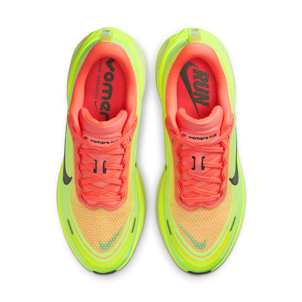 Neon green and pink running shoes with Nike logo on a white background.