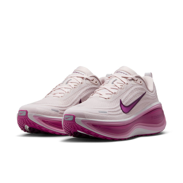 A pair of white and pink running shoes with a visible Nike logo on a white background