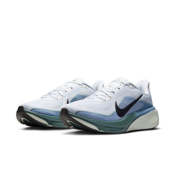 White running shoes with a blue gradient sole on a white background
