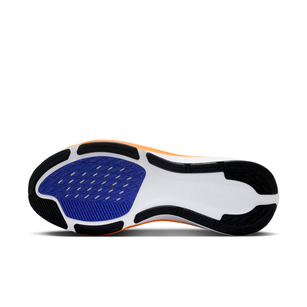 Close-up of a Nike running shoe sole with blue, black, and white design on a white background