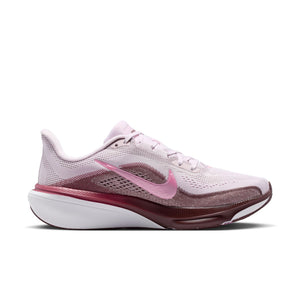 Pink and white running shoe with Nike logo on a white background
