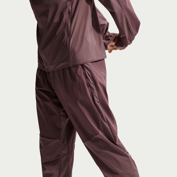 A side angle of a man wearing a Nike Running pant called the Stride Plus.
