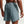 Person wearing a pair of gray athletic shorts on a plain background