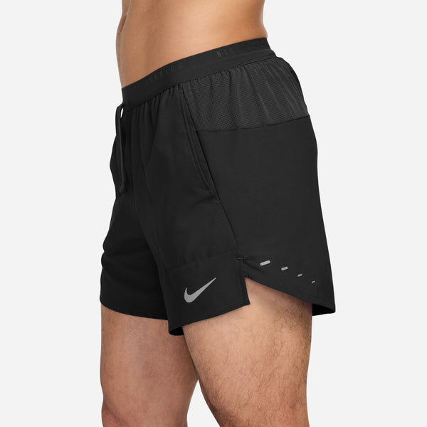 Black athletic shorts with a Nike logo on a white background