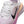 Close-up of a Nike running shoe in white mesh with a black Swoosh, pink and peach gradient accents, and white laces on a white background.