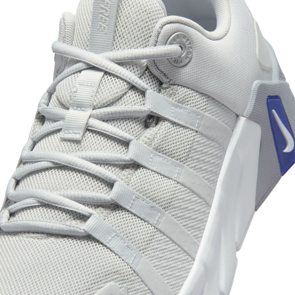 Gray athletic shoe with a blue swoosh logo on a white background