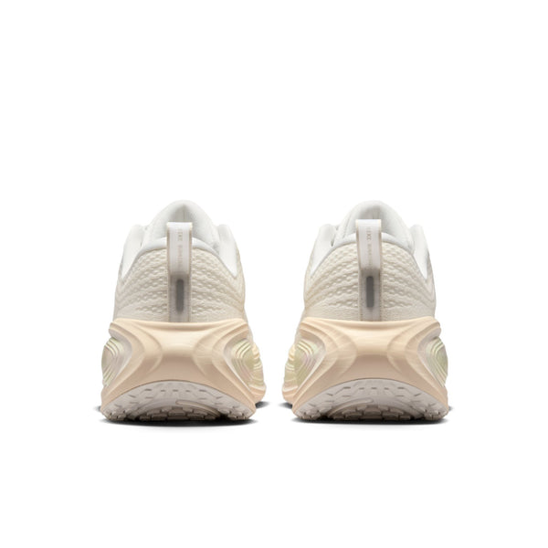Pair of white running shoes with a textured sole on a white background