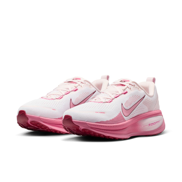 Pink and white running shoes with Nike logo on a white background