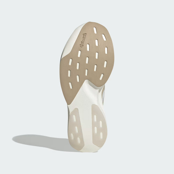 The outsole of a sneaker shown from a rear three-quarter view, featuring a dual-tone beige and off-white design with multiple circular cutouts, on a light gray background.