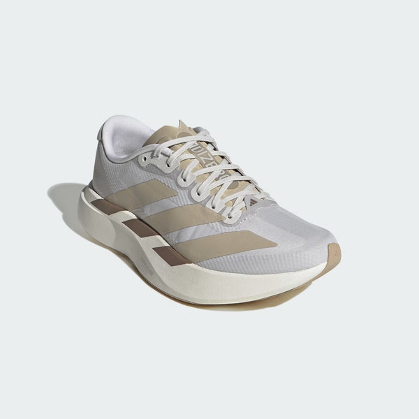 An Adidas running shoe in light gray and beige with white laces, shown from a three-quarters angle on a light gray background.