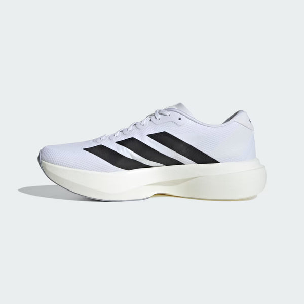 White athletic shoe with black stripes on a light gray background