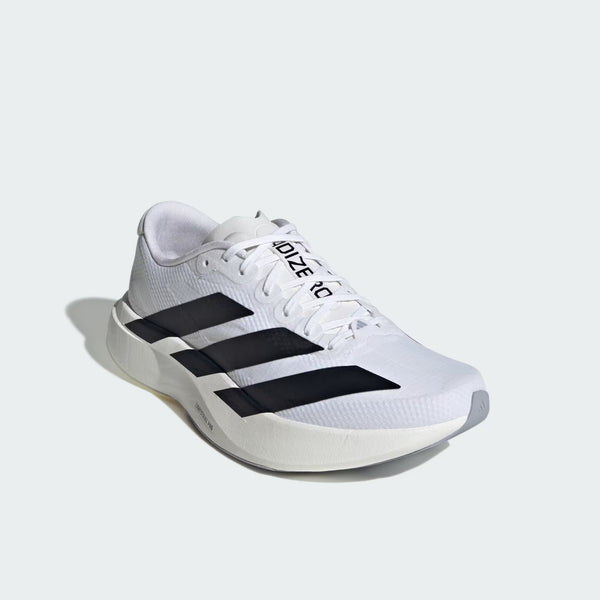 White athletic shoe with black stripes on a light gray background