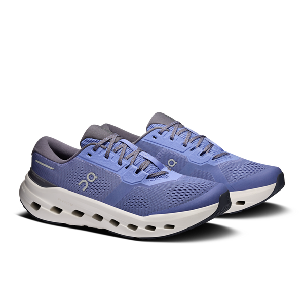 Blue running shoes with white sole on a white background