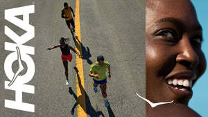 A banner image with the white HOKA logo to the left, an overhead view of three runners running down the yellow center line of a road and an up-close shot of a woman's face smiling to the far right.