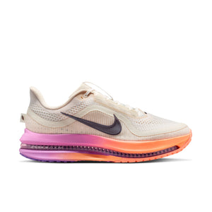 Beige running shoe with colorful sole on a white background