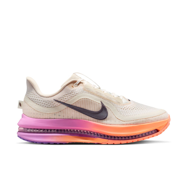 Beige running shoe with colorful sole on a white background